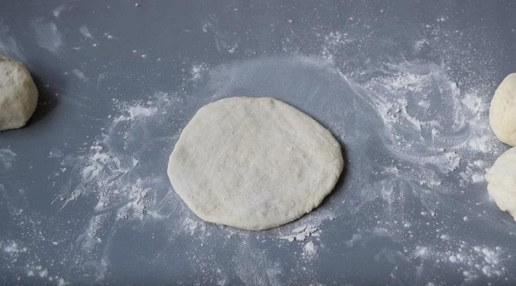 Each part of the dough is rolled into a cake.