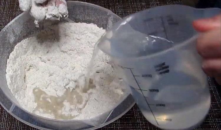 Add warm water to the dry ingredients in portions and knead the dough.