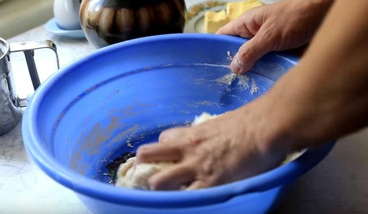 Knead the dough first in a bowl, and then on the table.