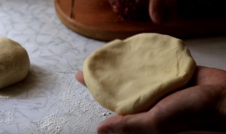Knead each ball of dough into a small cake.