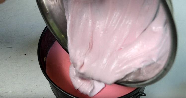 Pour pink souffle into shape on top of red.