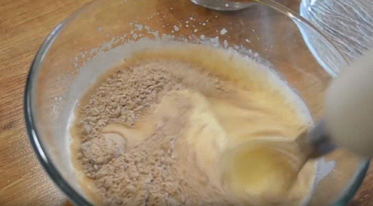 In parts we introduce dry components to liquid ones, whipping the dough with a mixer.