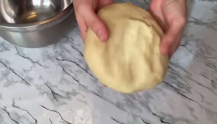 Knead the dough to make a custard bun.