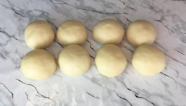 To make the custard yeast buns, divide the dough