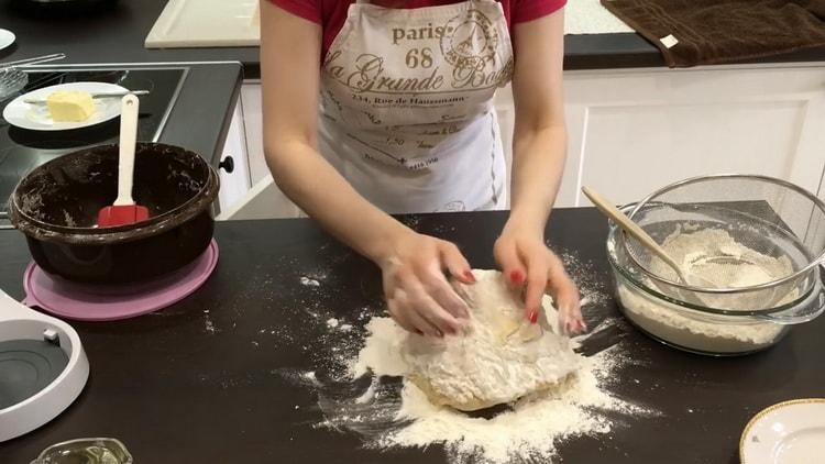 Knead the dough to make yeast buns with poppy seeds