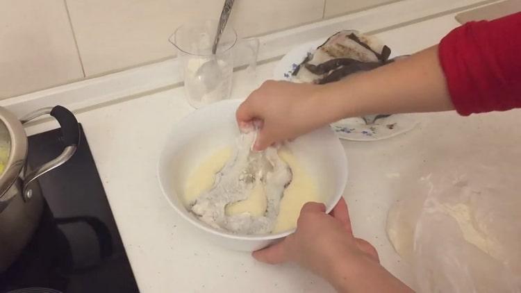 To cook catfish steak in a pan, soak the fish in batter