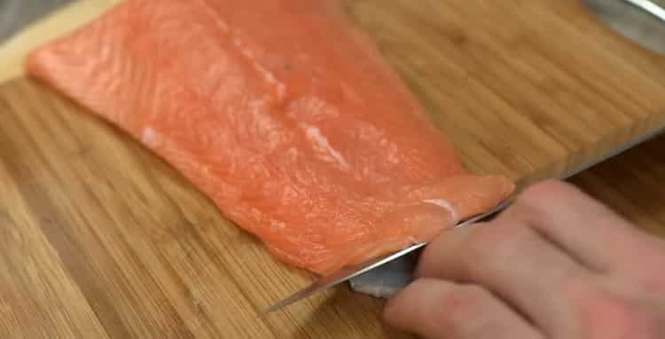 To make salmon carpaccio, cut the fish