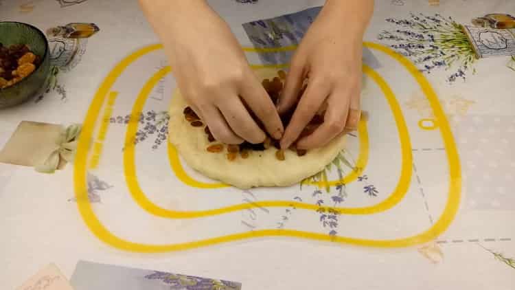 For cooking cakes on sour cream, lay dried fruits on the dough.