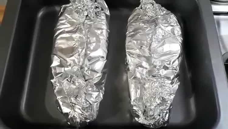 To cook salmon in the oven in foil, prepare the oven