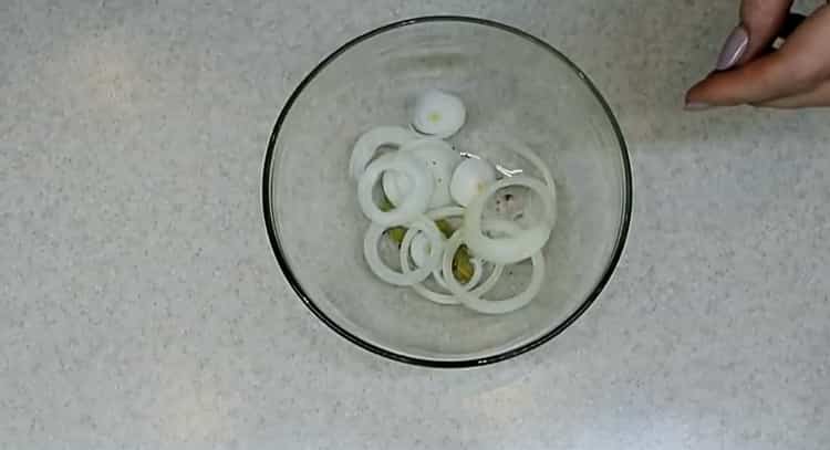 To prepare the pickled silver carp, chop the onion