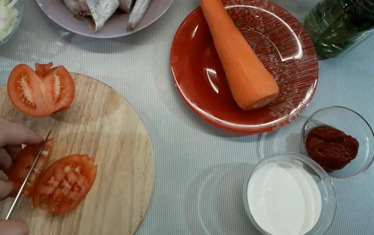 Para cocinar el abadejo en salsa de crema, corte los tomates.