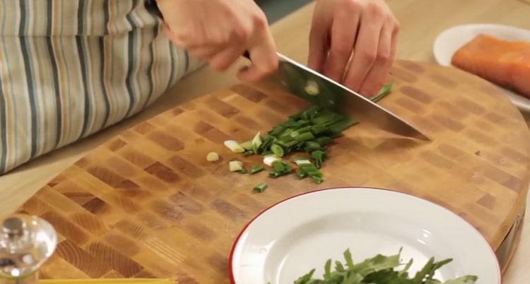To make salmon pasta, chop greens