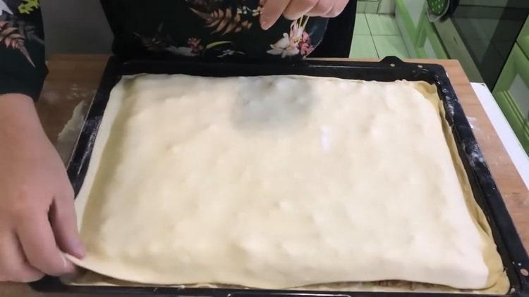 To make baklava from puff pastry, cover the top layer with dough