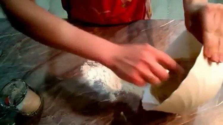 Knead the dough to make a donut with a hole.