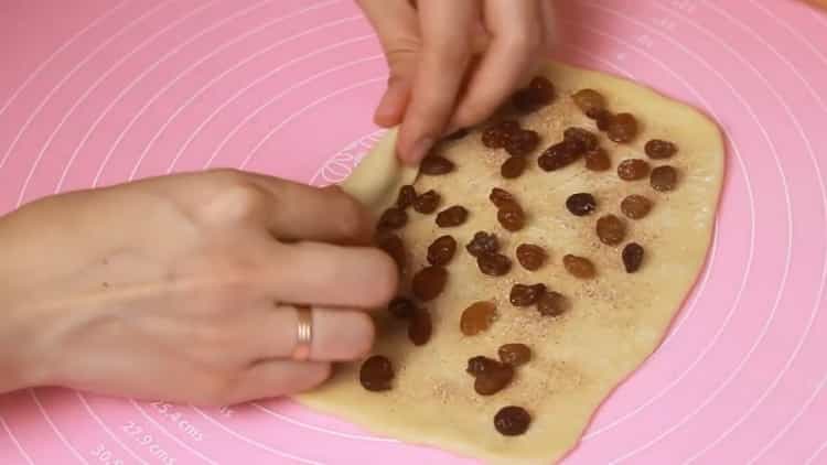 To make buns, put raisins on the dough