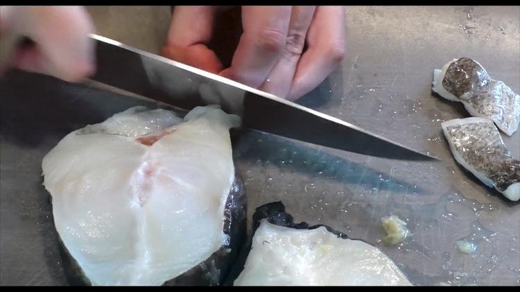 To cook catfish steak in the oven, clean the fish