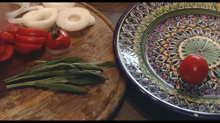 To cook catfish steak in the oven, prepare the vegetables