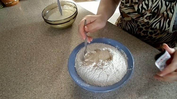 Sift the flour to make dough for pies with dry yeast
