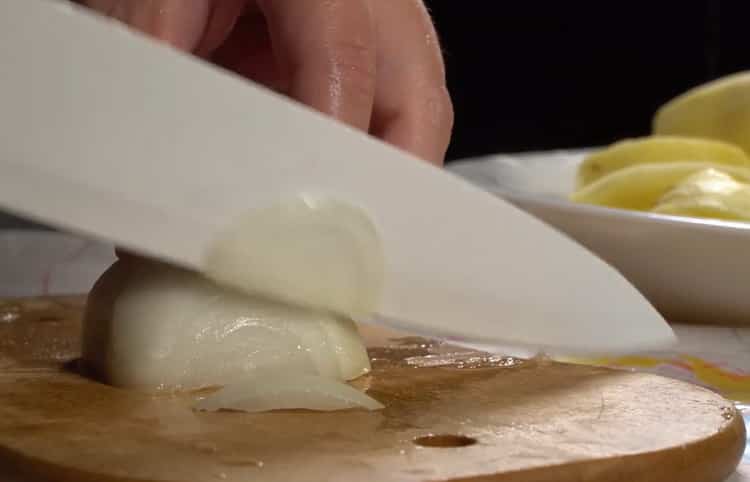 To prepare cod with potatoes in the oven, chop the onion