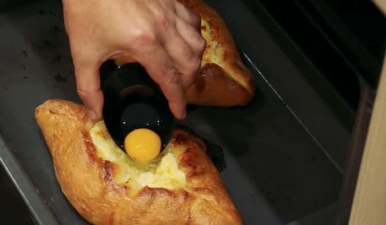 Add yolk to make khachapuri with egg and cheese