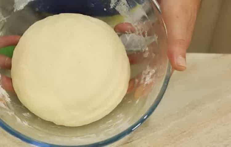 Knead the dough to make khachapuri boats