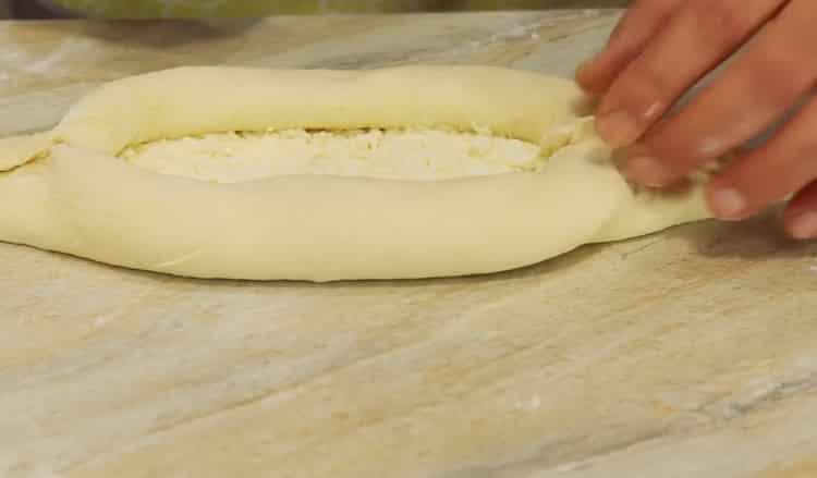 To make khachapuri with egg and cheese, give the desired shape