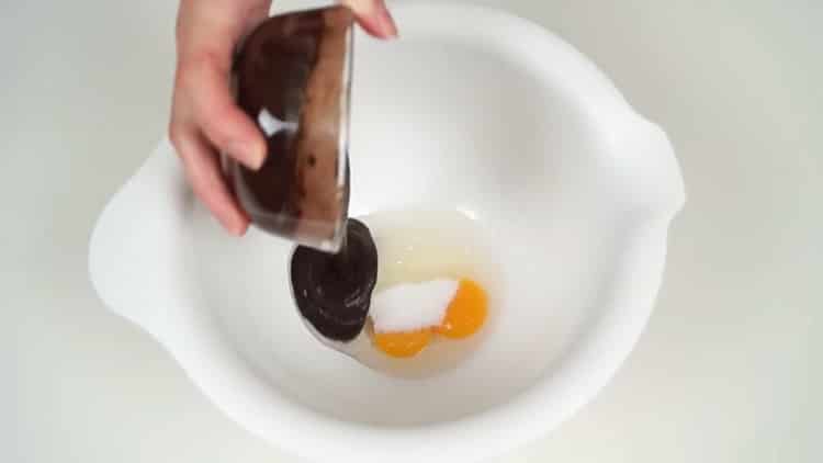 Beat the eggs to make a chocolate banana cake.