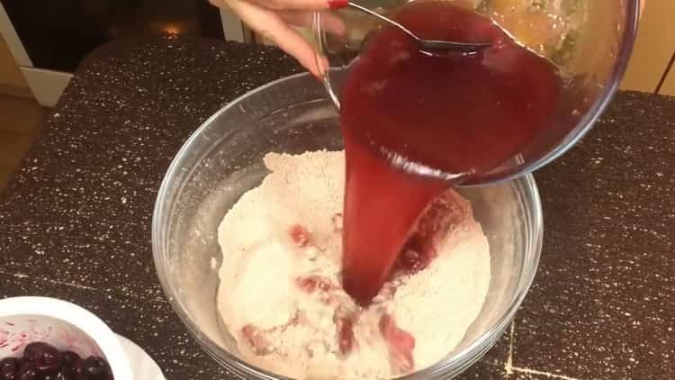 Mix liquid and dry ingredients to make a chocolate muffin with cherry