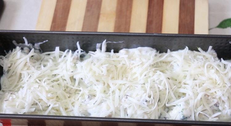 Sprinkle cheese on top of the dish and put the mold in the oven.