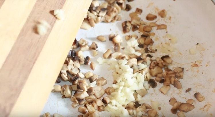 Add the garlic to the mushrooms.