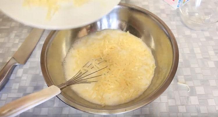 Add some cheese to the base for the casserole.