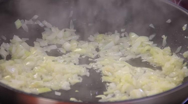 Fry chopped onions in a pan.