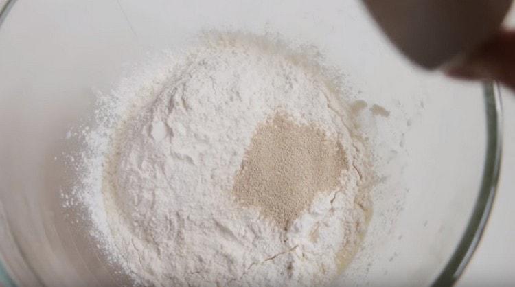 Sift flour into a bowl and add yeast.