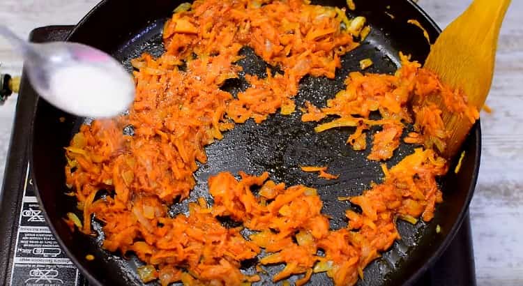 Add tomato paste, salt and sugar to the vegetables in the pan.