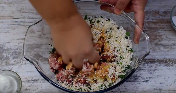 Thoroughly mix the stuffing for stuffed cabbage.