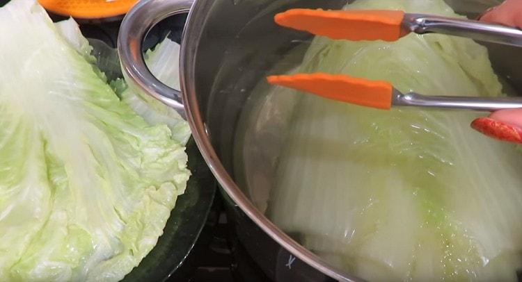 We put the cabbage in a pot with boiling water, when cooking, the leaves separate themselves.