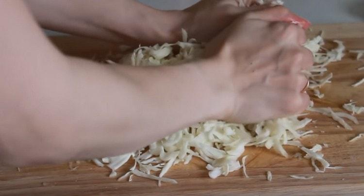 Salt cabbage and mash hands.