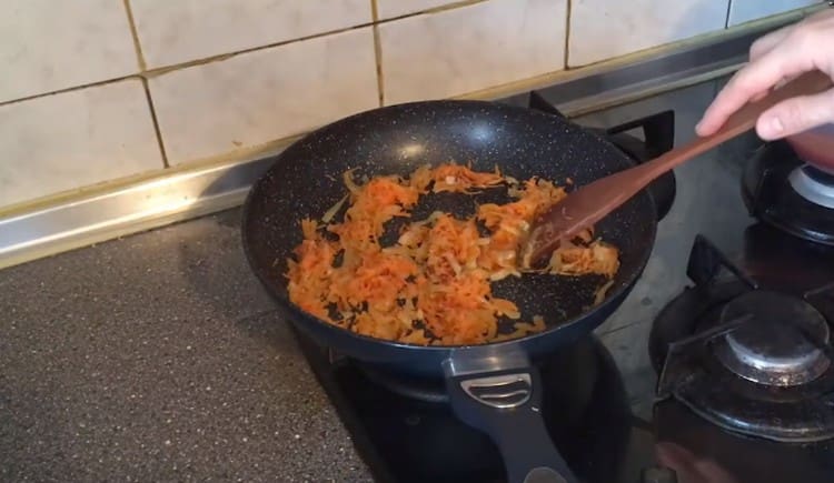 Add the grated carrot to the onion.