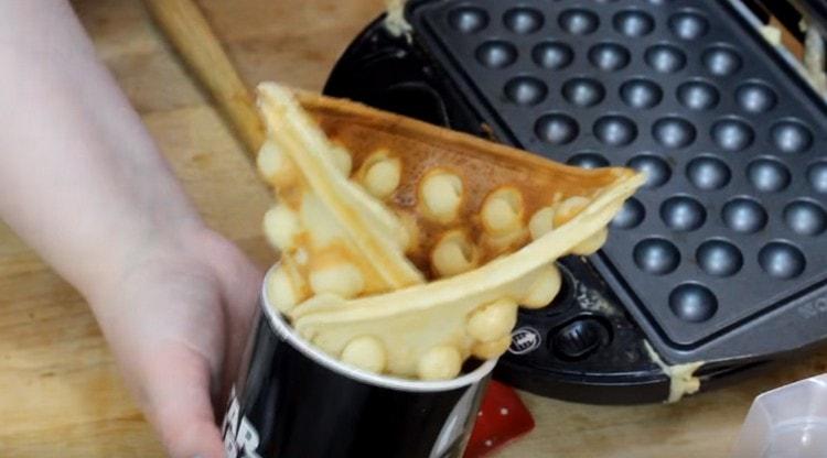 While the waffle is hot, you can give it any shape.