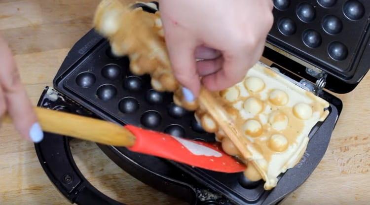 Gently take out the finished waffle.