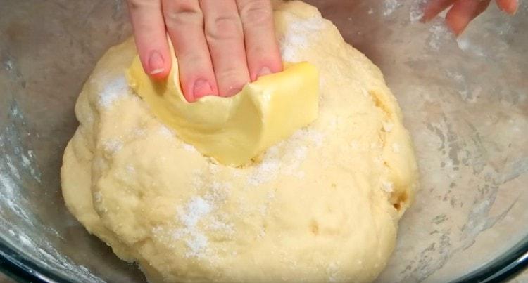 After 20 minutes, add salt and soft butter to the dough.