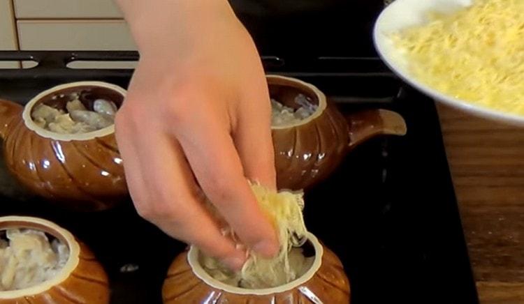 We shift the julienne into pots, sprinkle with grated cheese.