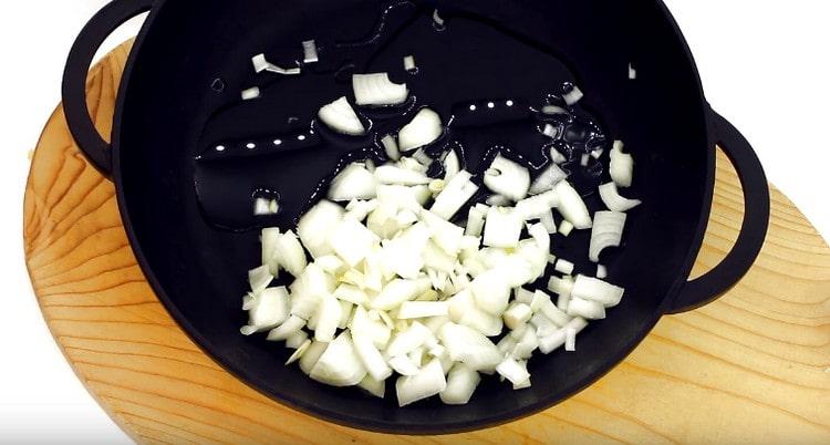 Fry chopped onions in a pan.