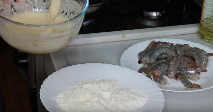 Roll each shrimp in flour, and then dip in batter.