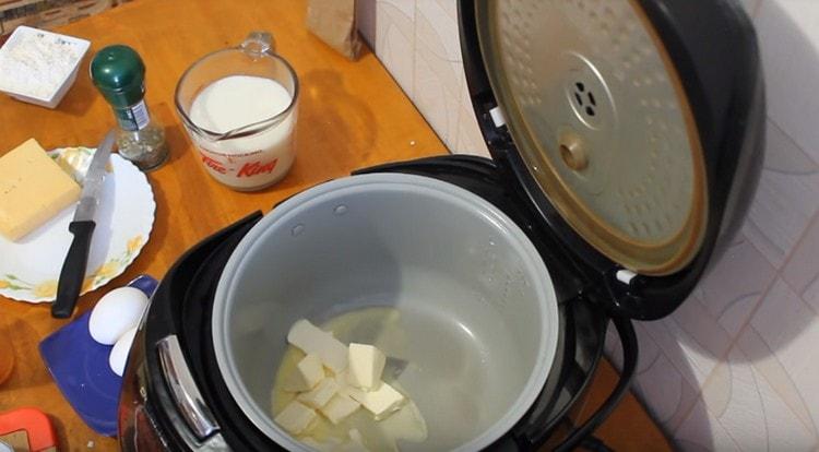 In the number of the multicooker bowl we spread the butter.