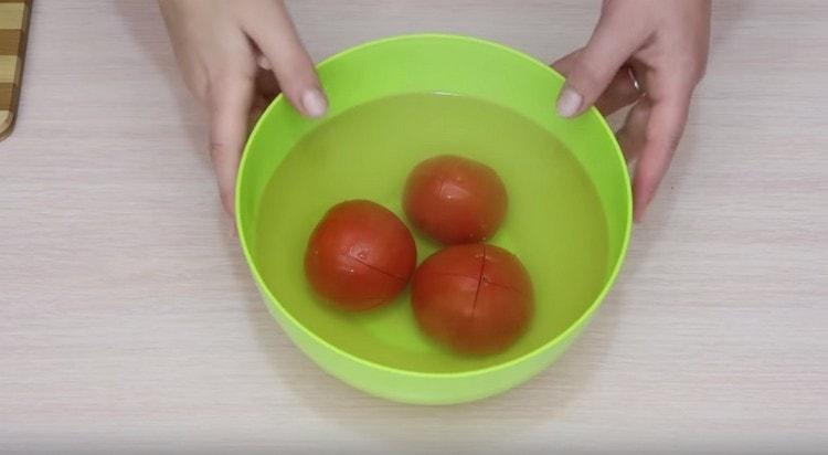 Giet kokend water over de tomaten.