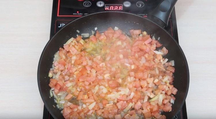 Add tomatoes to the onion, fry until soft.