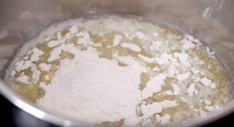 Add flour to the oil and mix quickly.