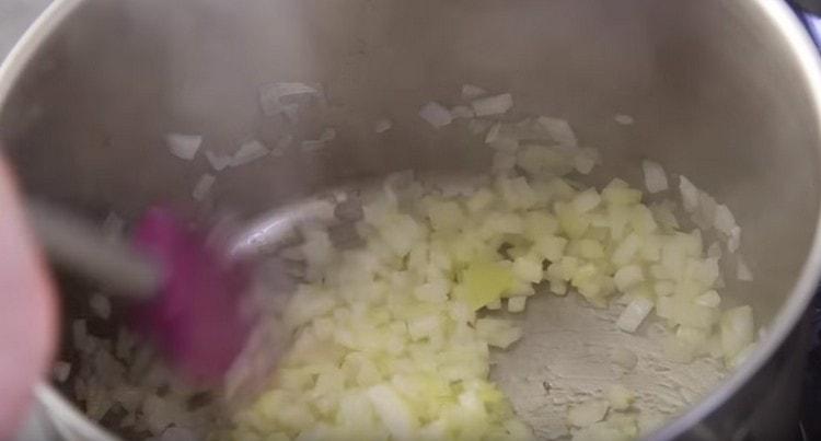 We saute onions in a stewpan.