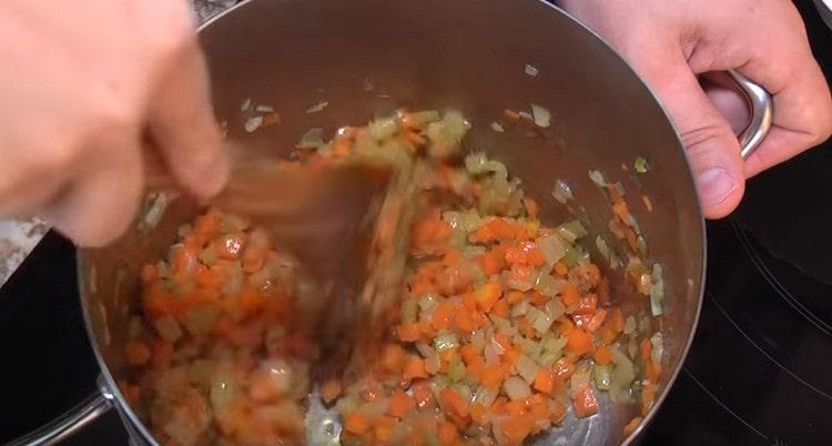 Add carrots and celery to the onion.